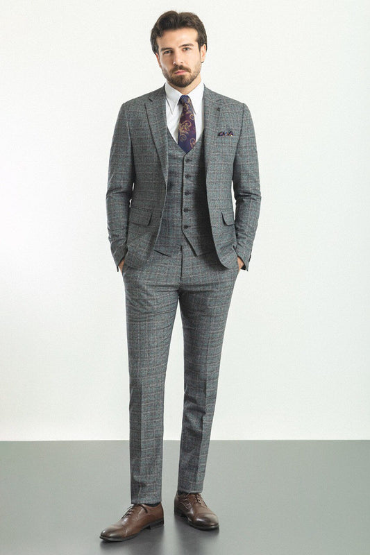 Man wearing a plaid dark gray 3-piece suit with a patterned tie, showcasing sophisticated menswear from Suitharbor.