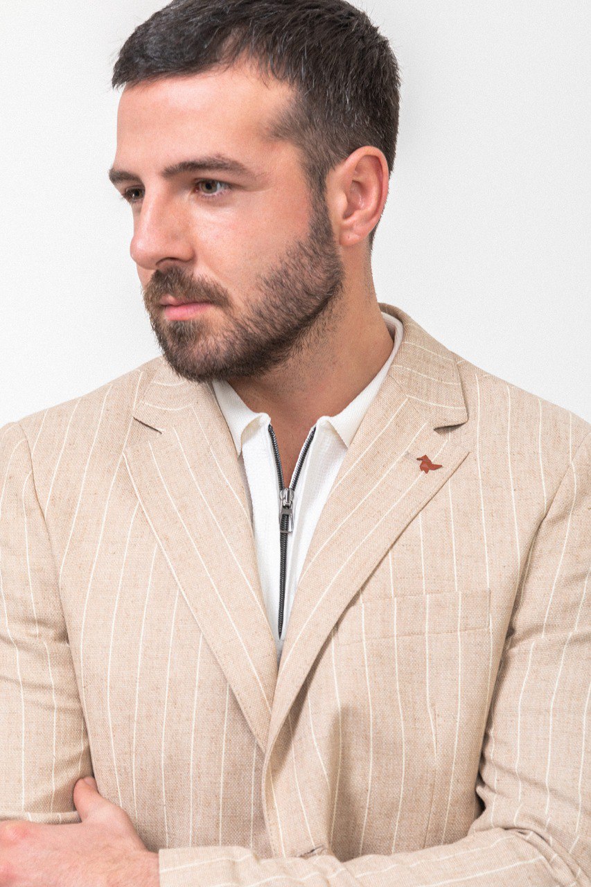 Man wearing a beige pinstripe blazer.