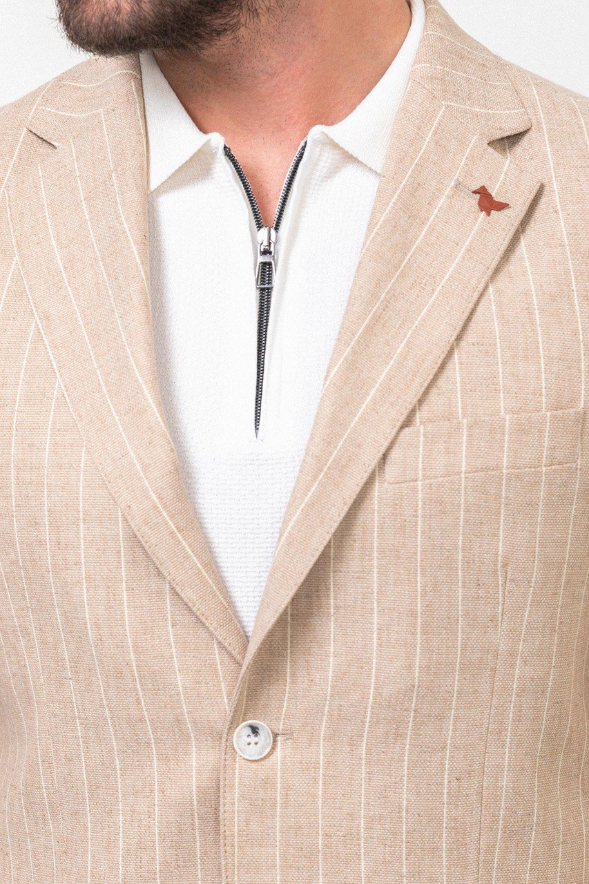 Man wearing a beige pinstripe blazer.