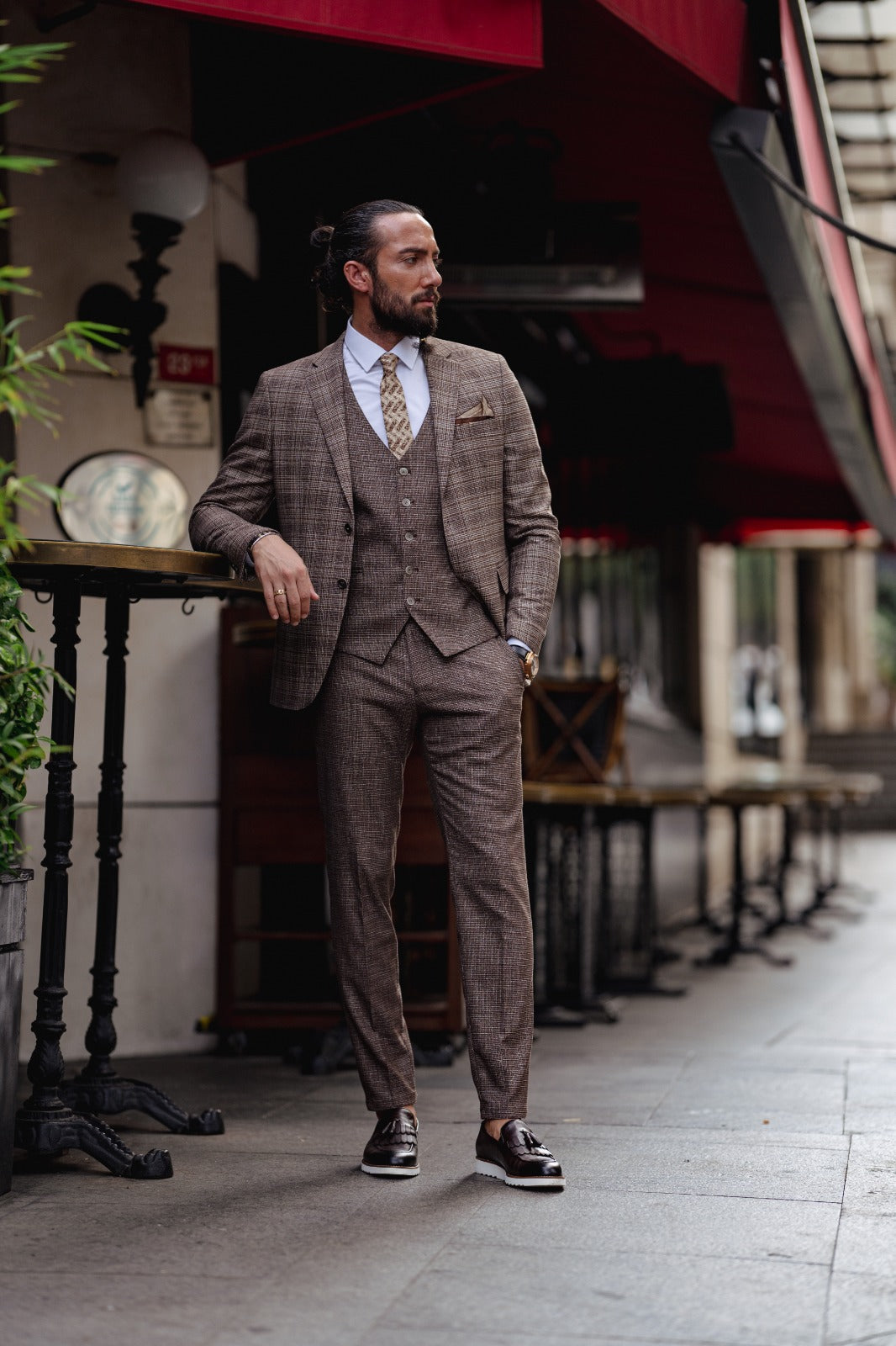 A Brown Slim Fit Plaid Detailed Suit on display.