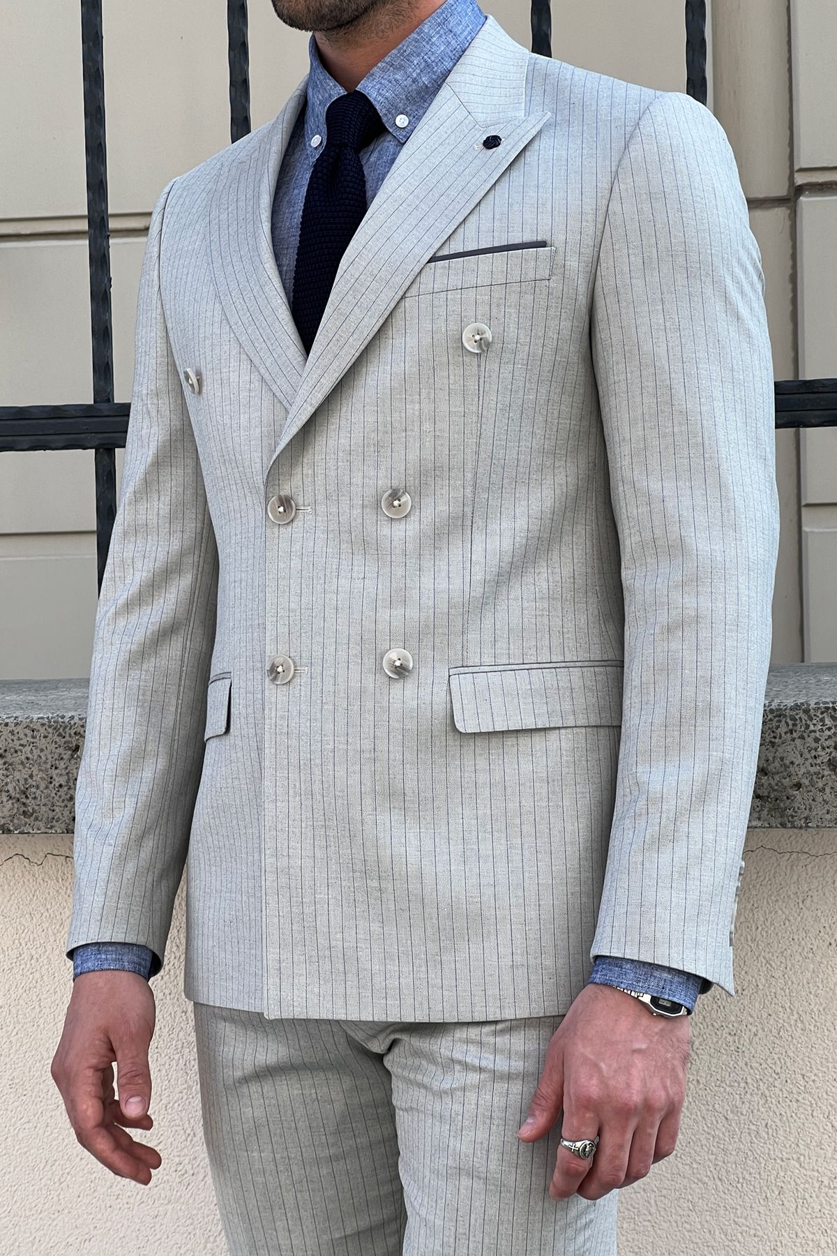 Model wearing a sharp double-breasted gray wool suit.