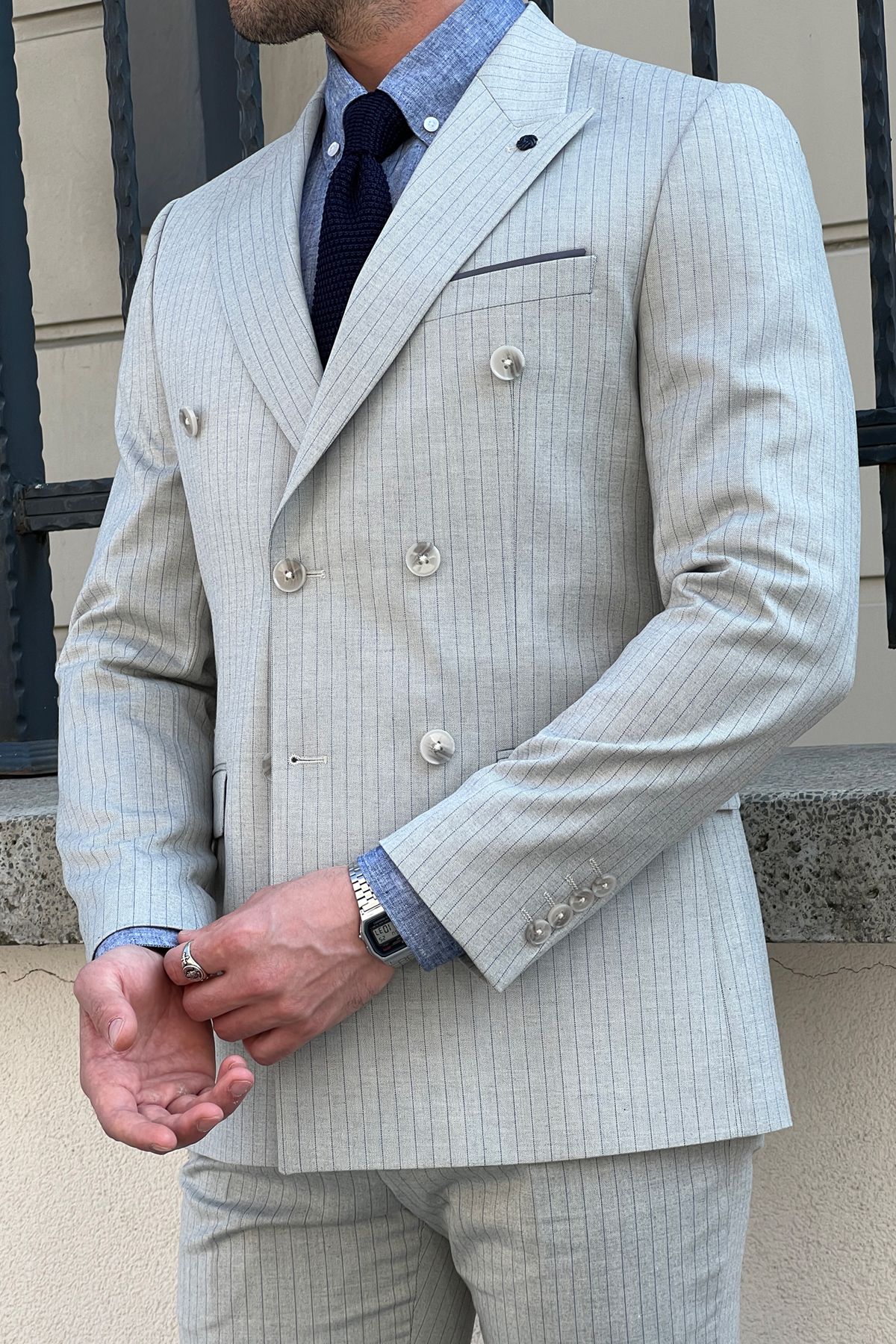 Model wearing a sharp double-breasted gray wool suit.