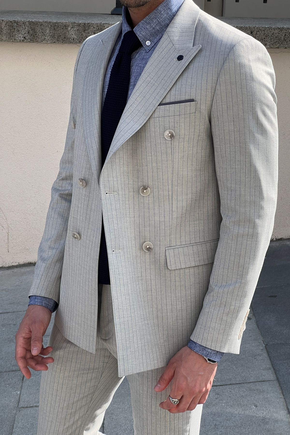 Model wearing a sharp double-breasted gray wool suit.