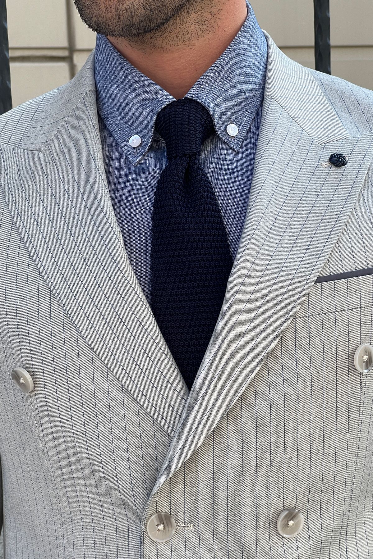 Model wearing a sharp double-breasted gray wool suit.