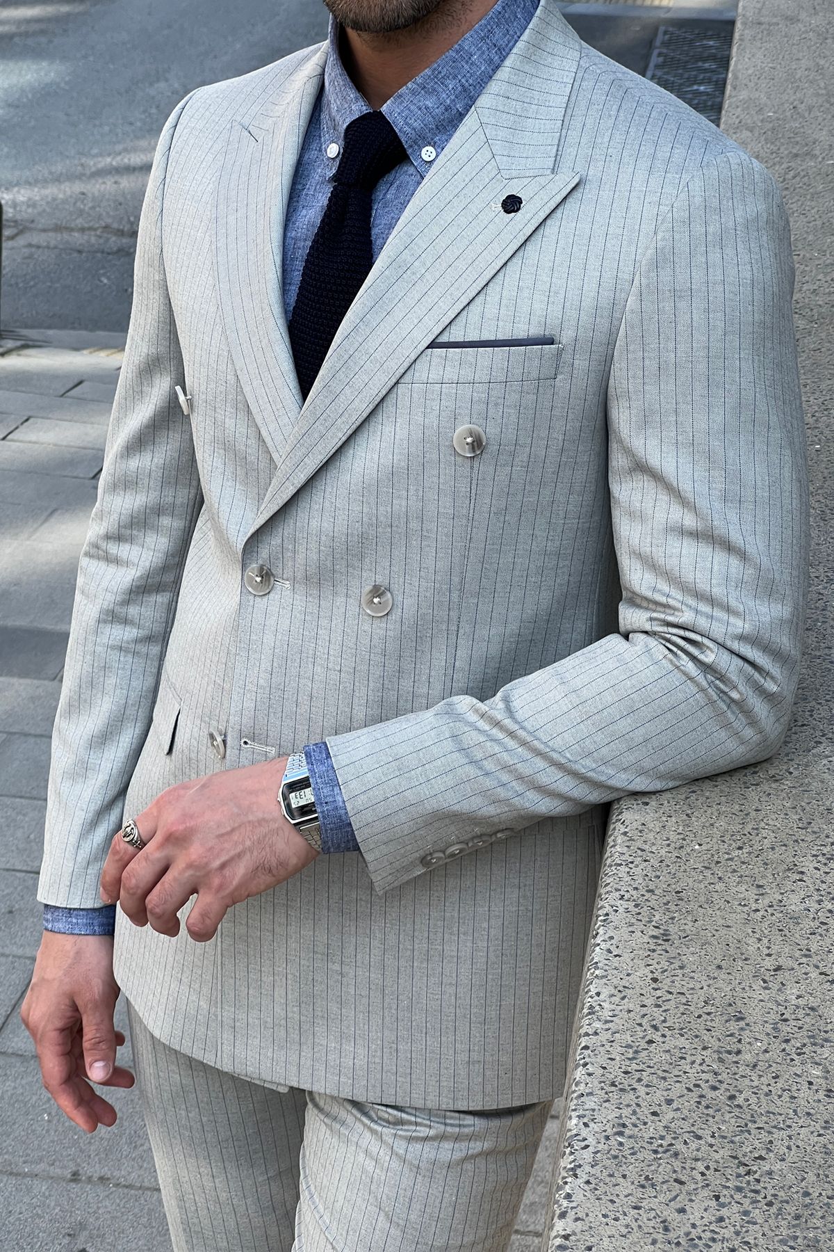 Model wearing a sharp double-breasted gray wool suit.