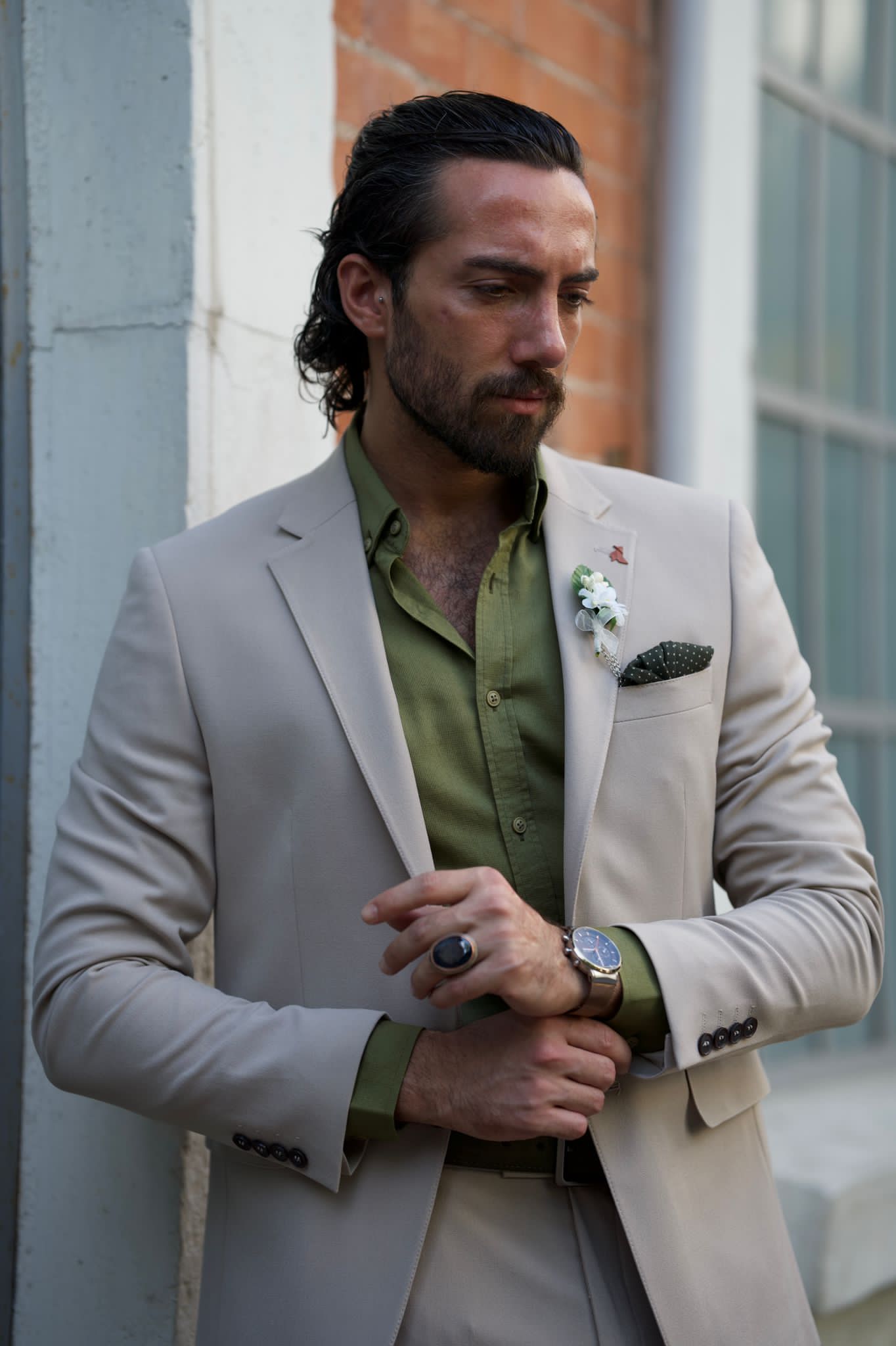 Male model looking dapper in a beige suit
