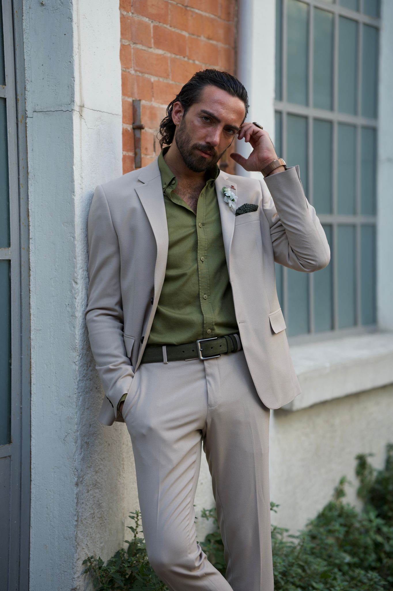 Male model looking dapper in a beige suit