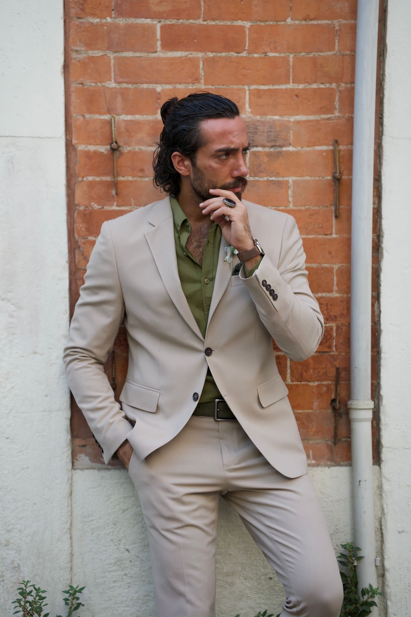 Male model looking dapper in a beige suit