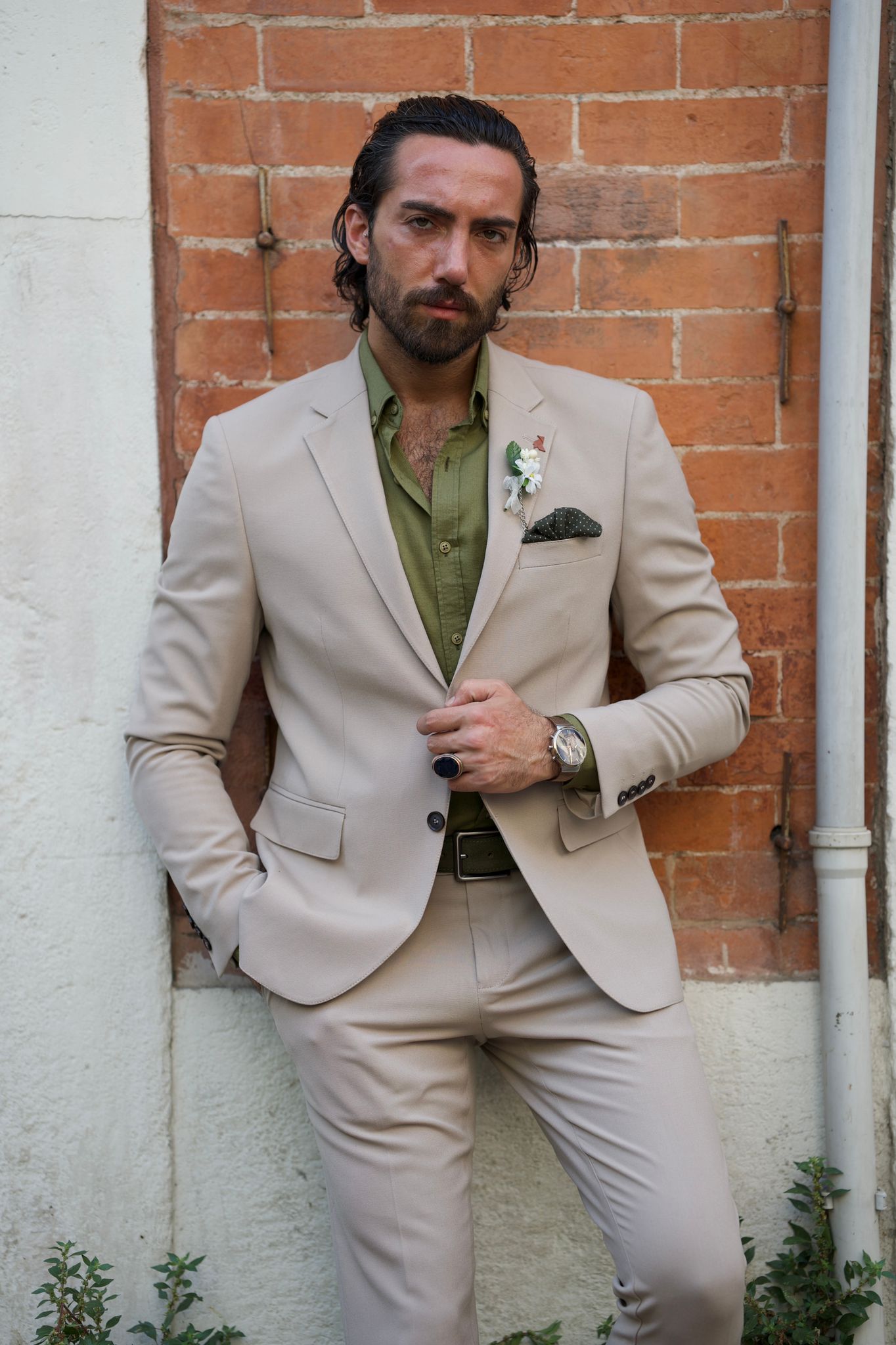 Male model looking dapper in a beige suit