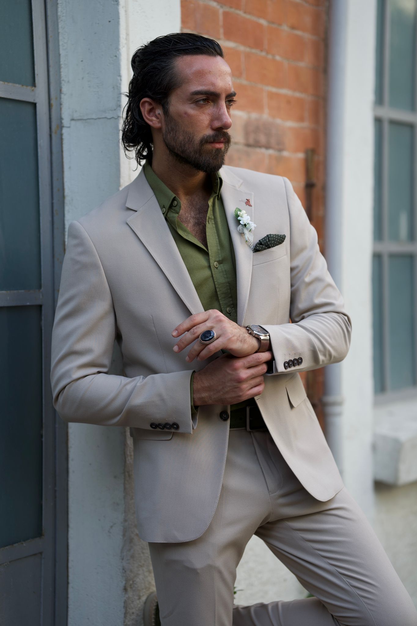 Male model looking dapper in a beige suit