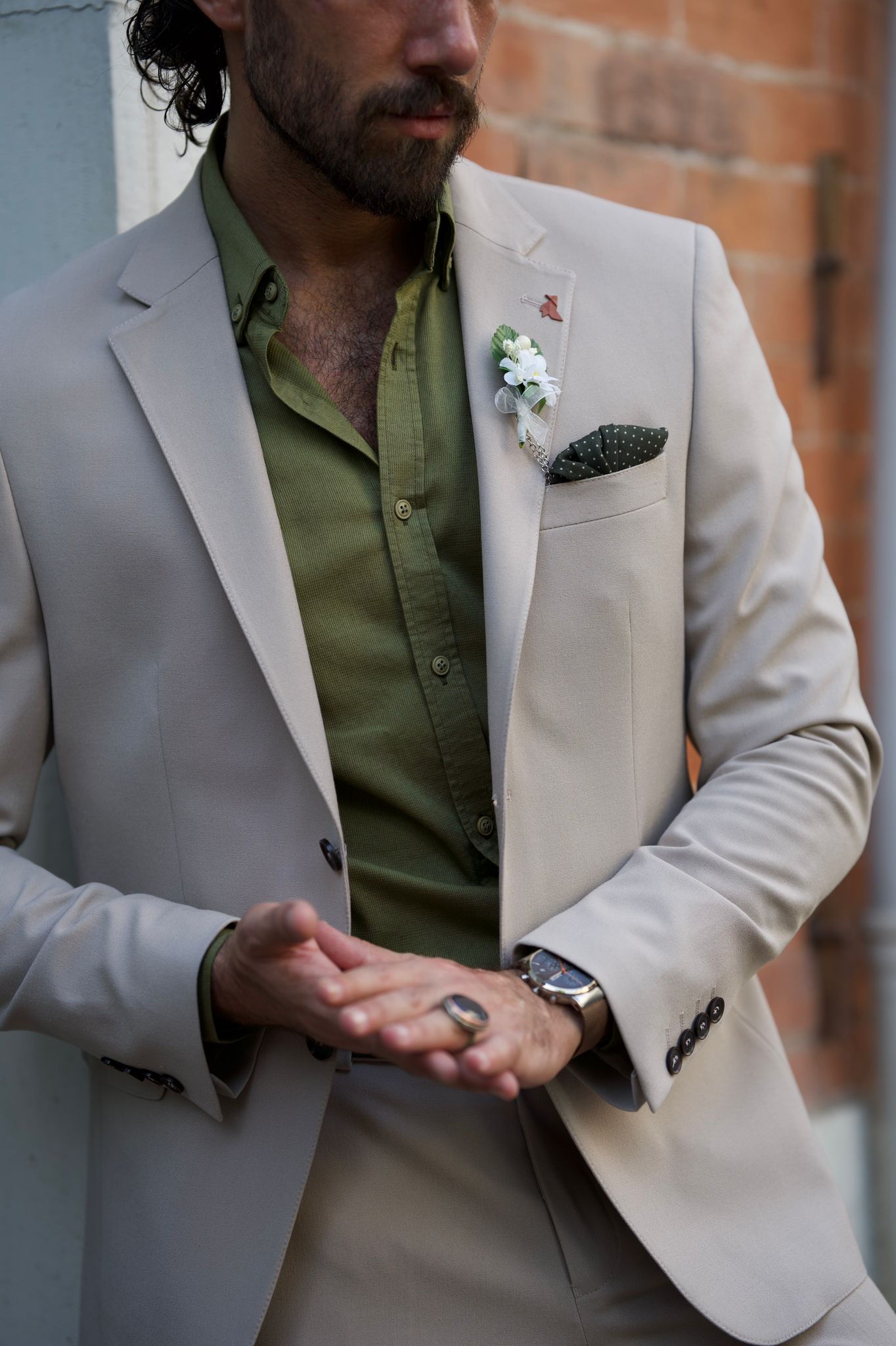 Male model looking dapper in a beige suit