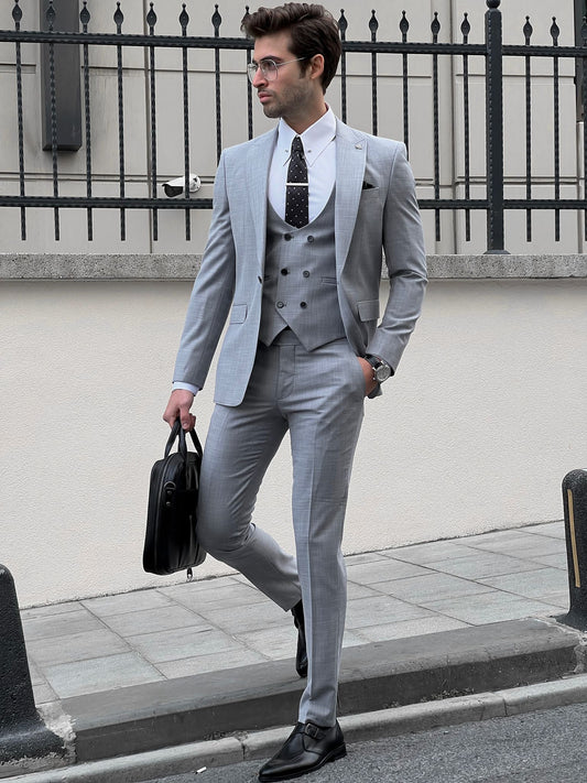 Confident man wearing a fitted gray suit.