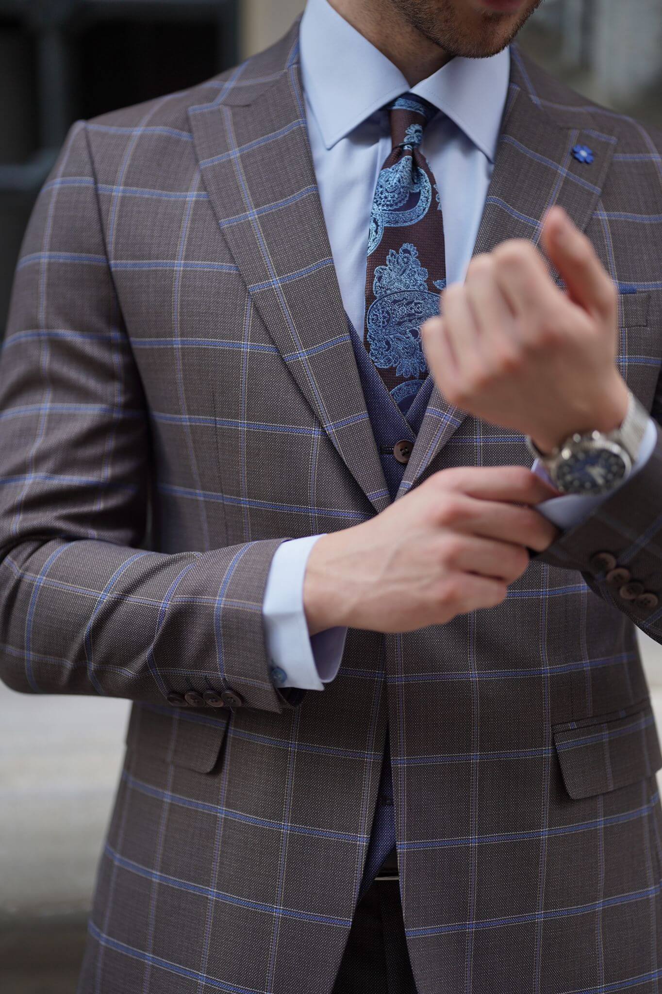 A Slim-Fit Plaid Brown Wool Combination Suit on display.