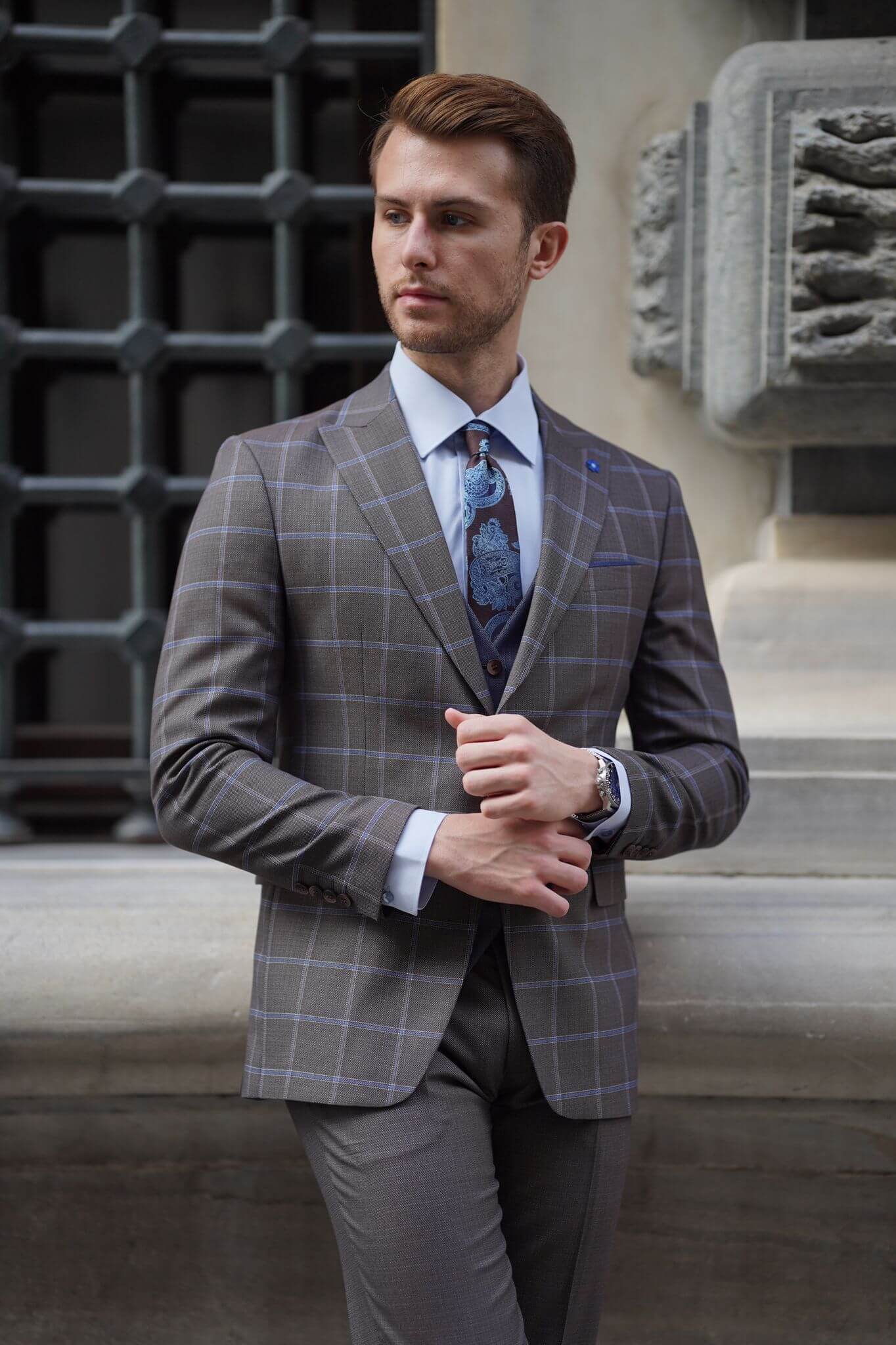 A Slim-Fit Plaid Brown Wool Combination Suit on display.