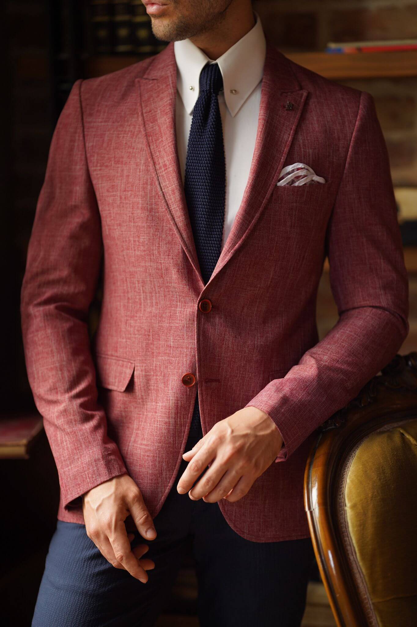 A Slim-Fit Self patterned Cotton Claret Red Blazer on display.