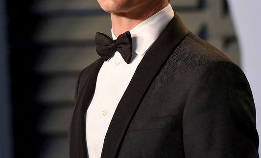 A man dressed in a black tuxedo