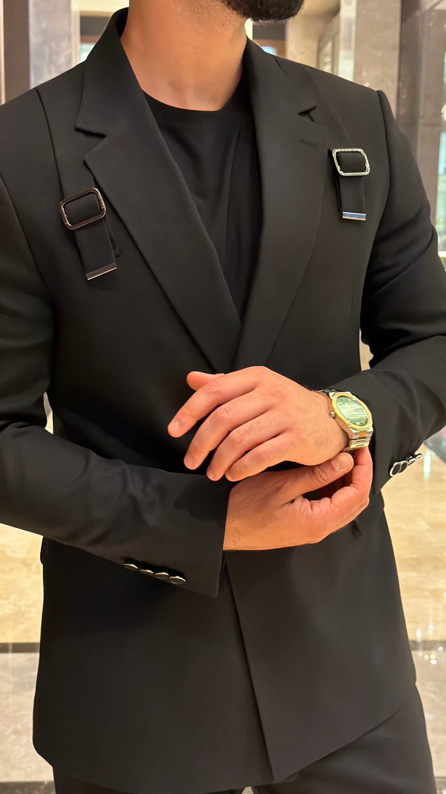 Men's black wedding suit shown from an angled view