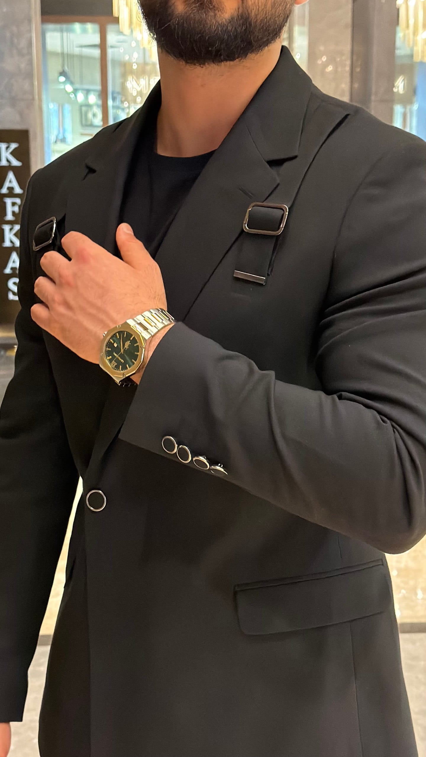 Full-length black buckle-strap suit with matching trousers