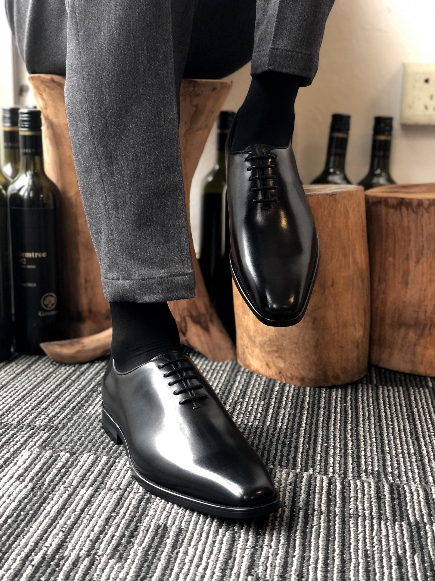 A pair of sleek Black Leather Oxford Shoes, featuring a polished finish, ideal for formal wear and business attire.