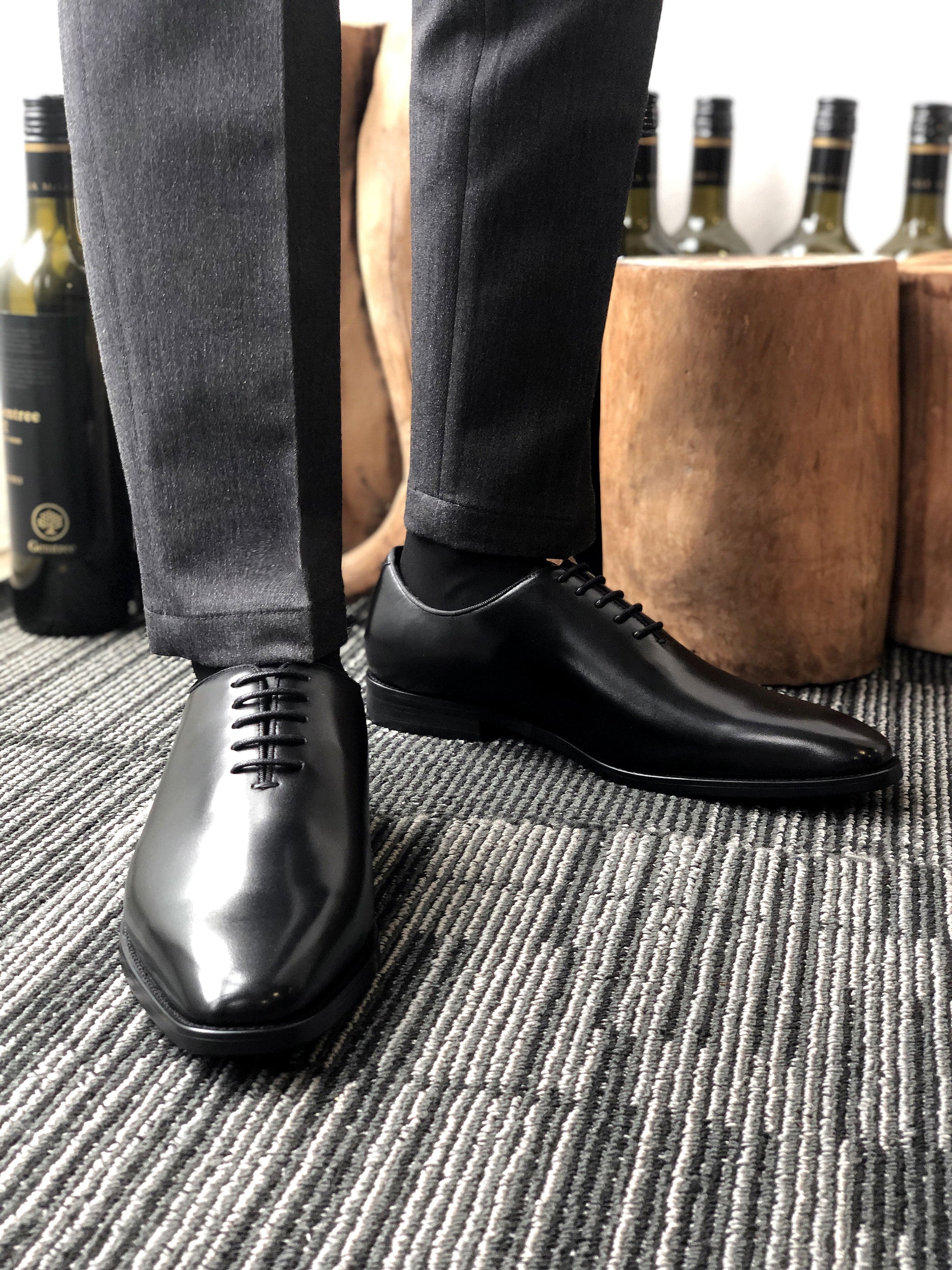 A pair of sleek Black Leather Oxford Shoes, featuring a polished finish, ideal for formal wear and business attire.