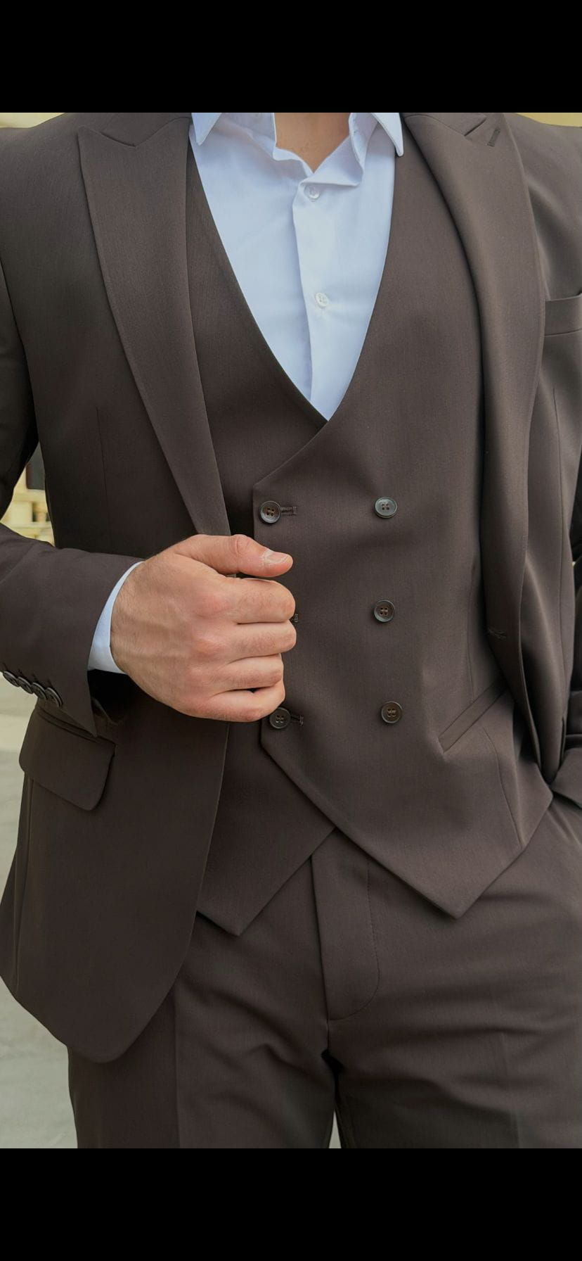 Men's brown suit showing coordinated jacket, waistcoat, and trouser styling
