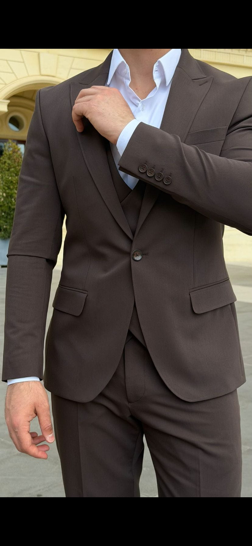 Brown three-piece suit featuring a matching double-breasted waistcoat