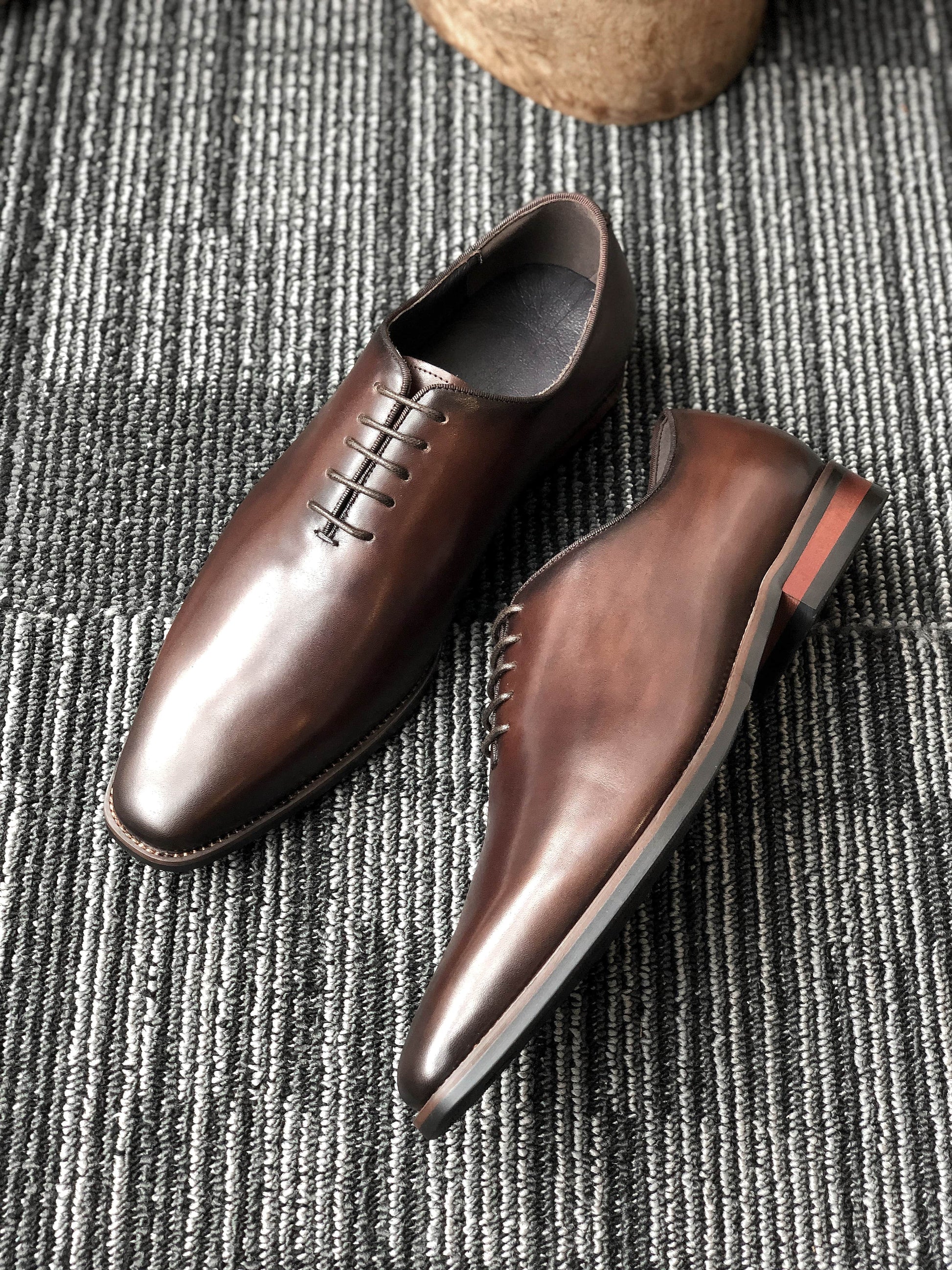 A pair of handcrafted Brown Leather Oxford Shoes, featuring a polished finish and sleek design, ideal for formal wear and business attire.