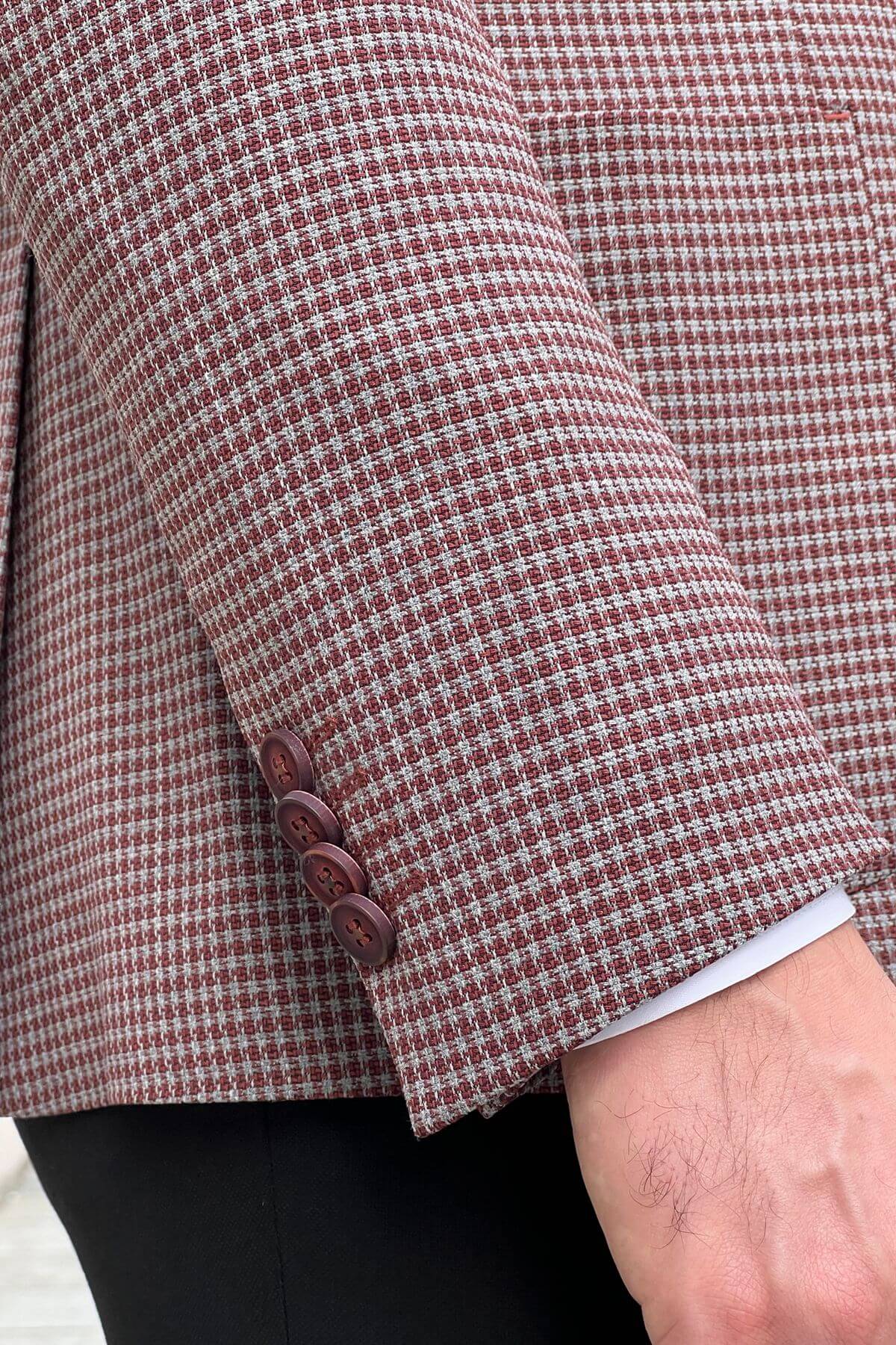 Close-up of a checkered jacket with buttons on a blurred background