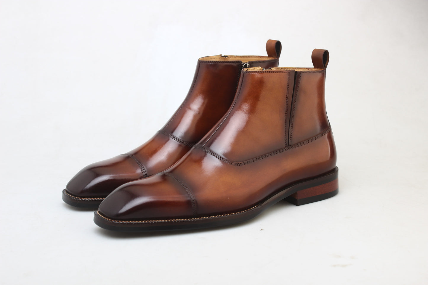 A pair of handcrafted Chestnut Leather Boots with a polished finish, featuring a sleek and elegant design, perfect for formal and business wear.