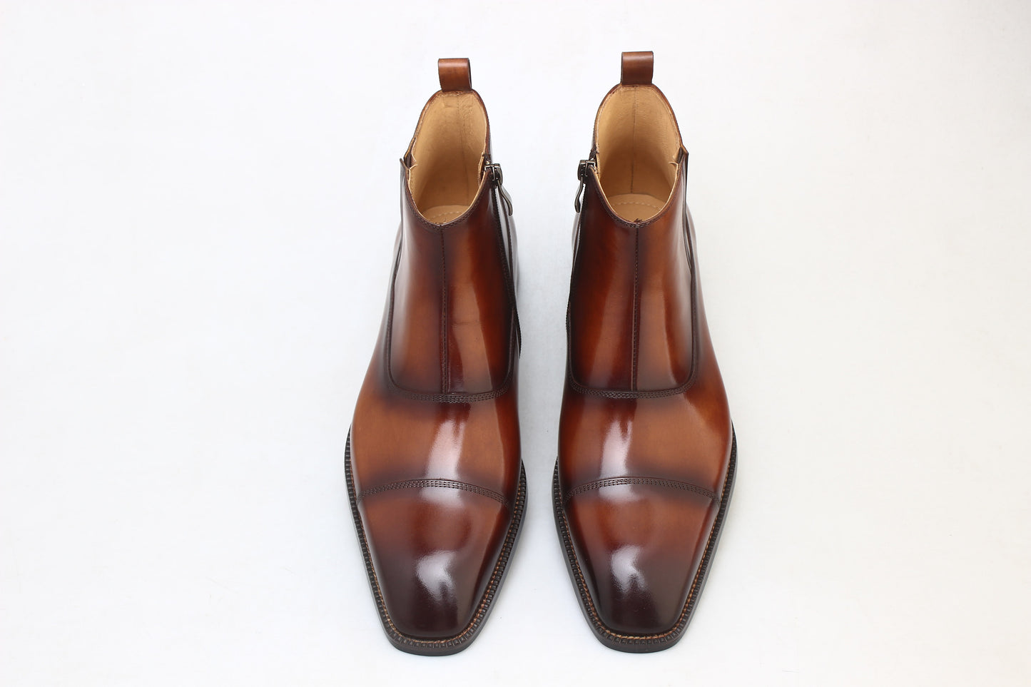 A pair of handcrafted Chestnut Leather Boots with a polished finish, featuring a sleek and elegant design, perfect for formal and business wear.