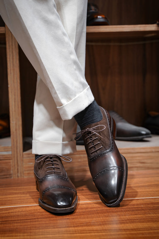 Top view of men's chestnut leather and suede oxford shoes, featuring a two-tone design and cap-toe detailing, perfect for formal occasions and luxury fashion.