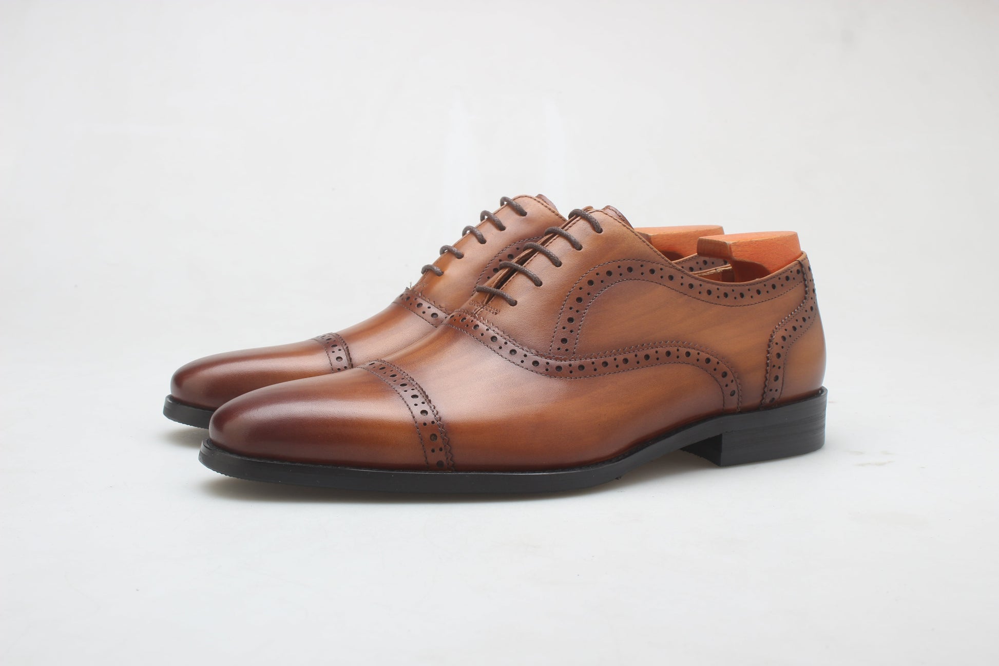 A pair of Cognac Brown Brogue Oxford Shoes, crafted from premium leather with elegant brogue detailing, perfect for formal and business wear.