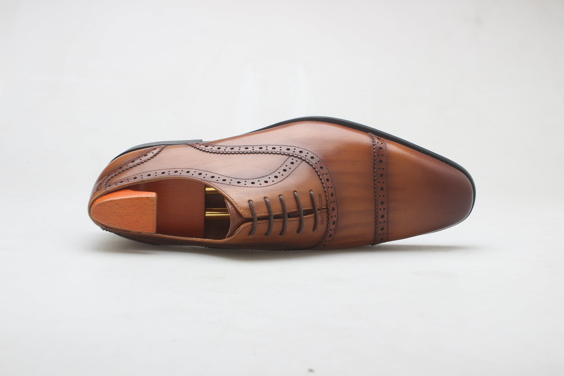 A pair of Cognac Brown Brogue Oxford Shoes, crafted from premium leather with elegant brogue detailing, perfect for formal and business wear.