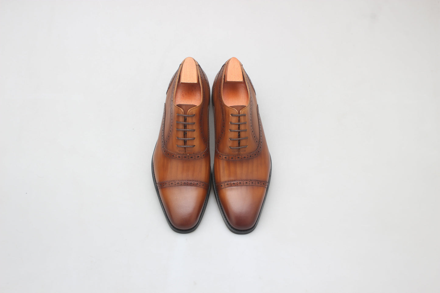 A pair of Cognac Brown Brogue Oxford Shoes, crafted from premium leather with elegant brogue detailing, perfect for formal and business wear.