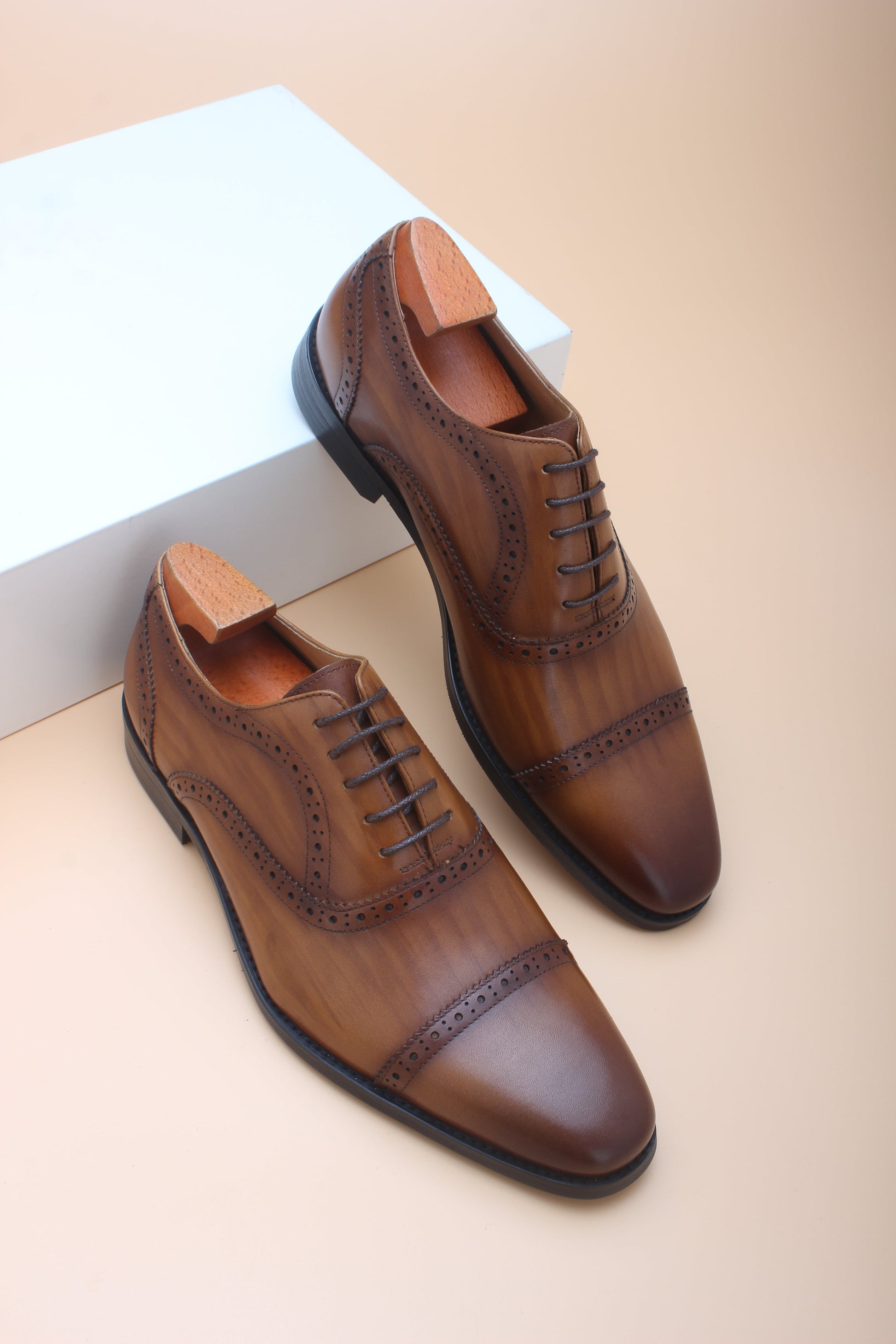 A pair of Cognac Brown Brogue Oxford Shoes, crafted from premium leather with elegant brogue detailing, perfect for formal and business wear.