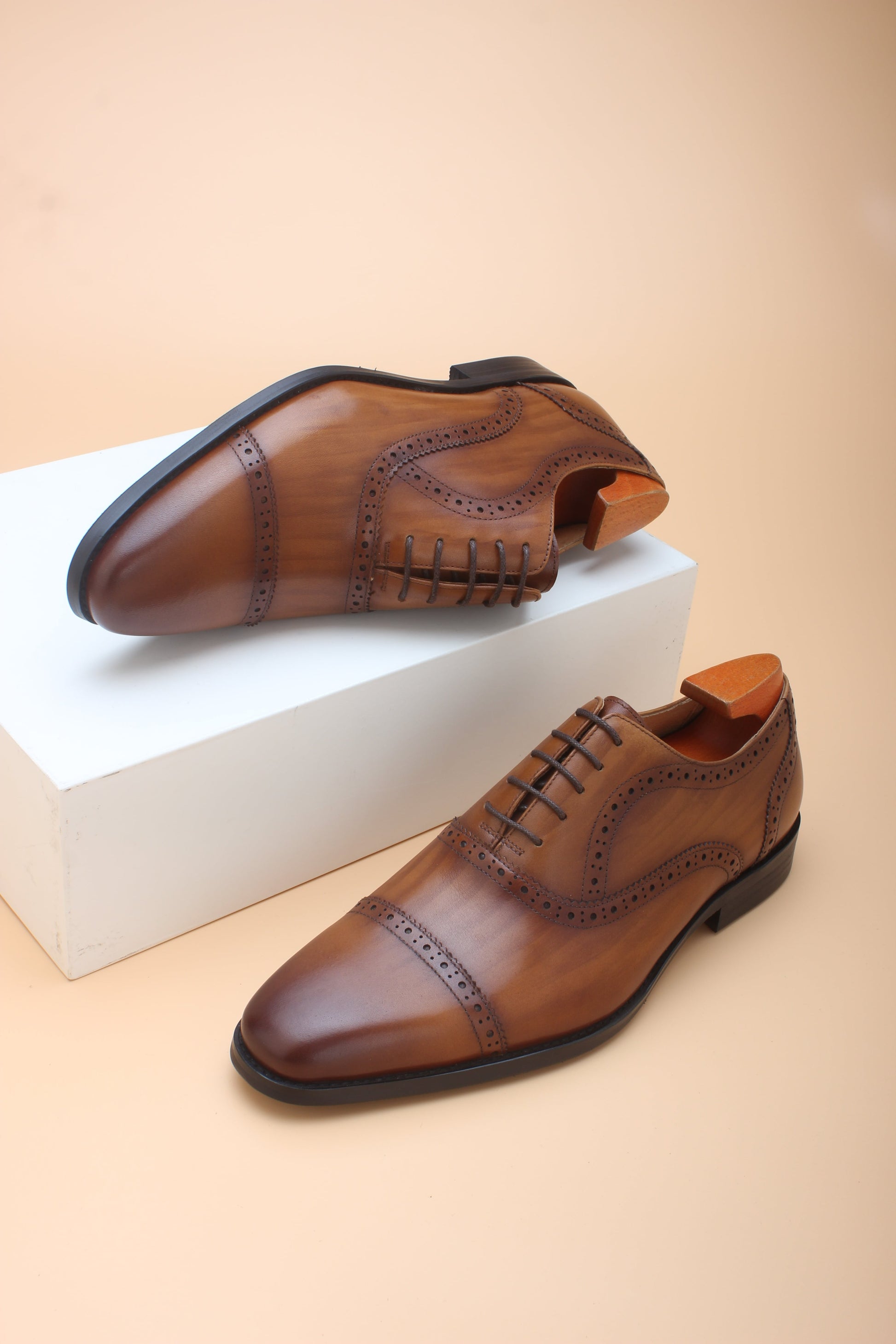 A pair of Cognac Brown Brogue Oxford Shoes, crafted from premium leather with elegant brogue detailing, perfect for formal and business wear.