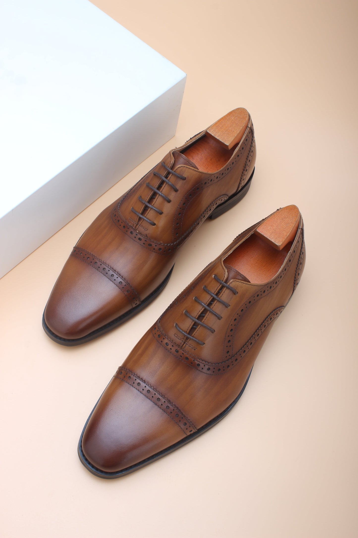 A pair of Cognac Brown Brogue Oxford Shoes, crafted from premium leather with elegant brogue detailing, perfect for formal and business wear.