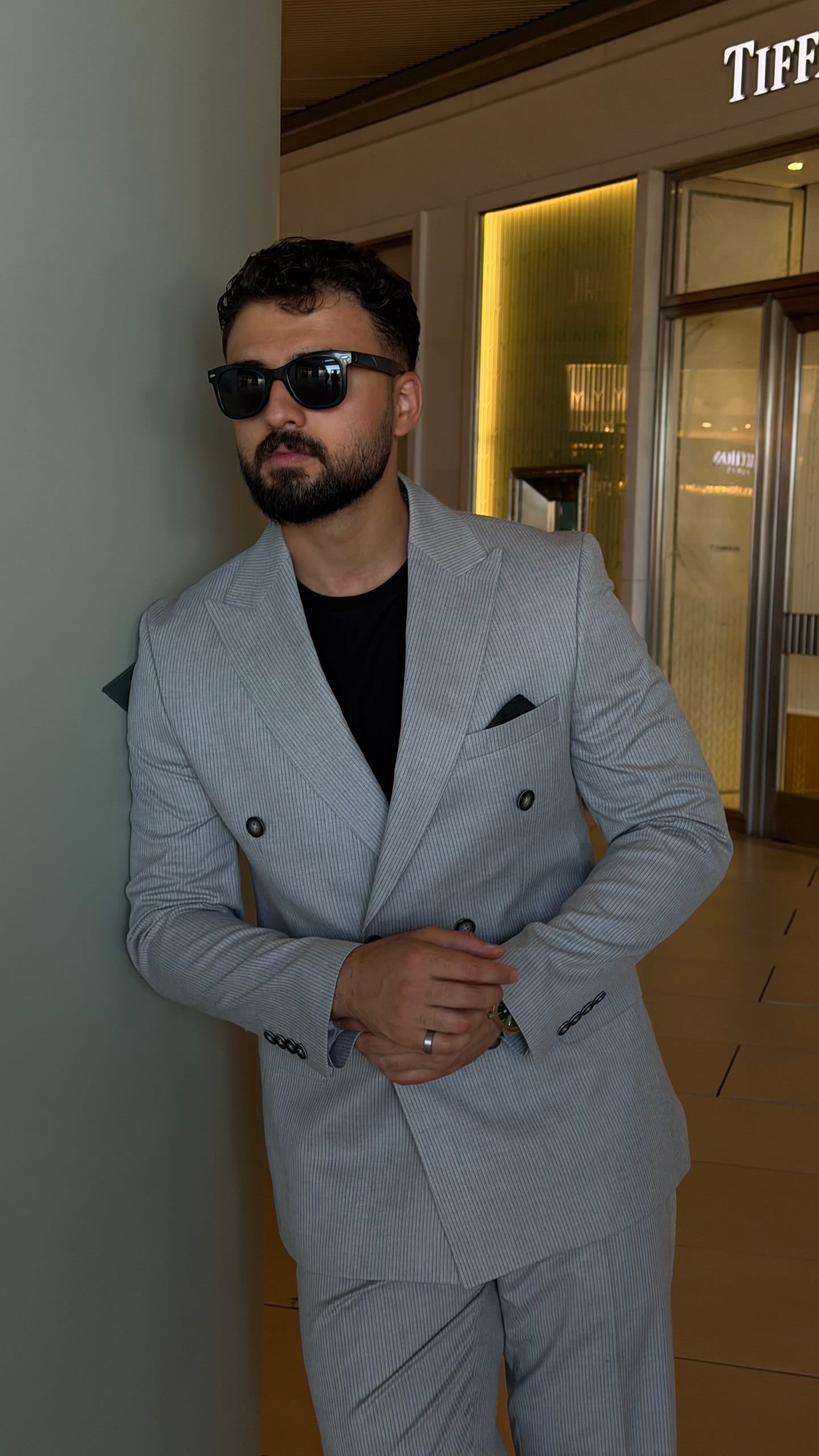 Light gray slim fit suit showing peak lapel and black buttons