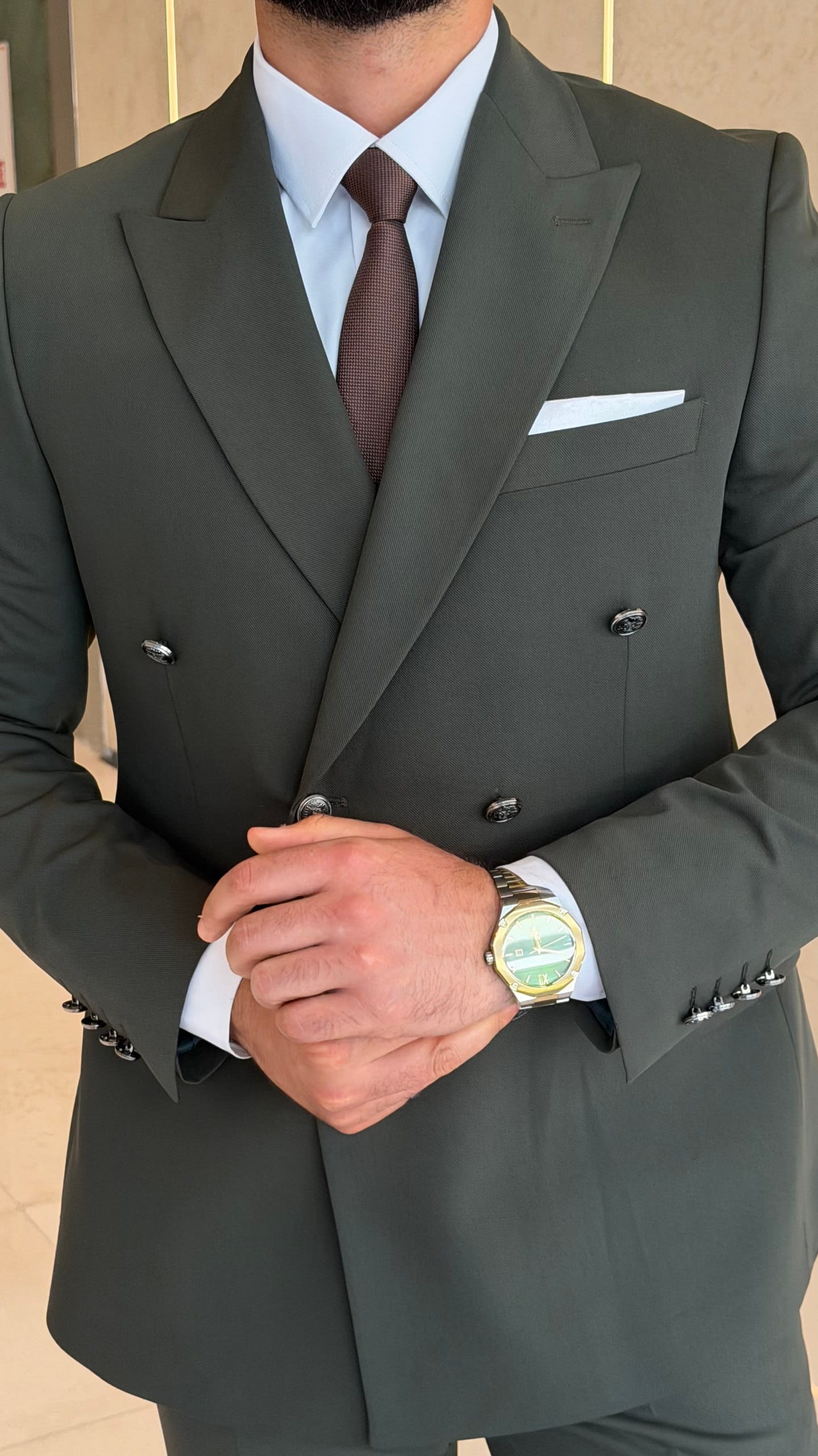 Men's khaki double-breasted suit shown from an angled view