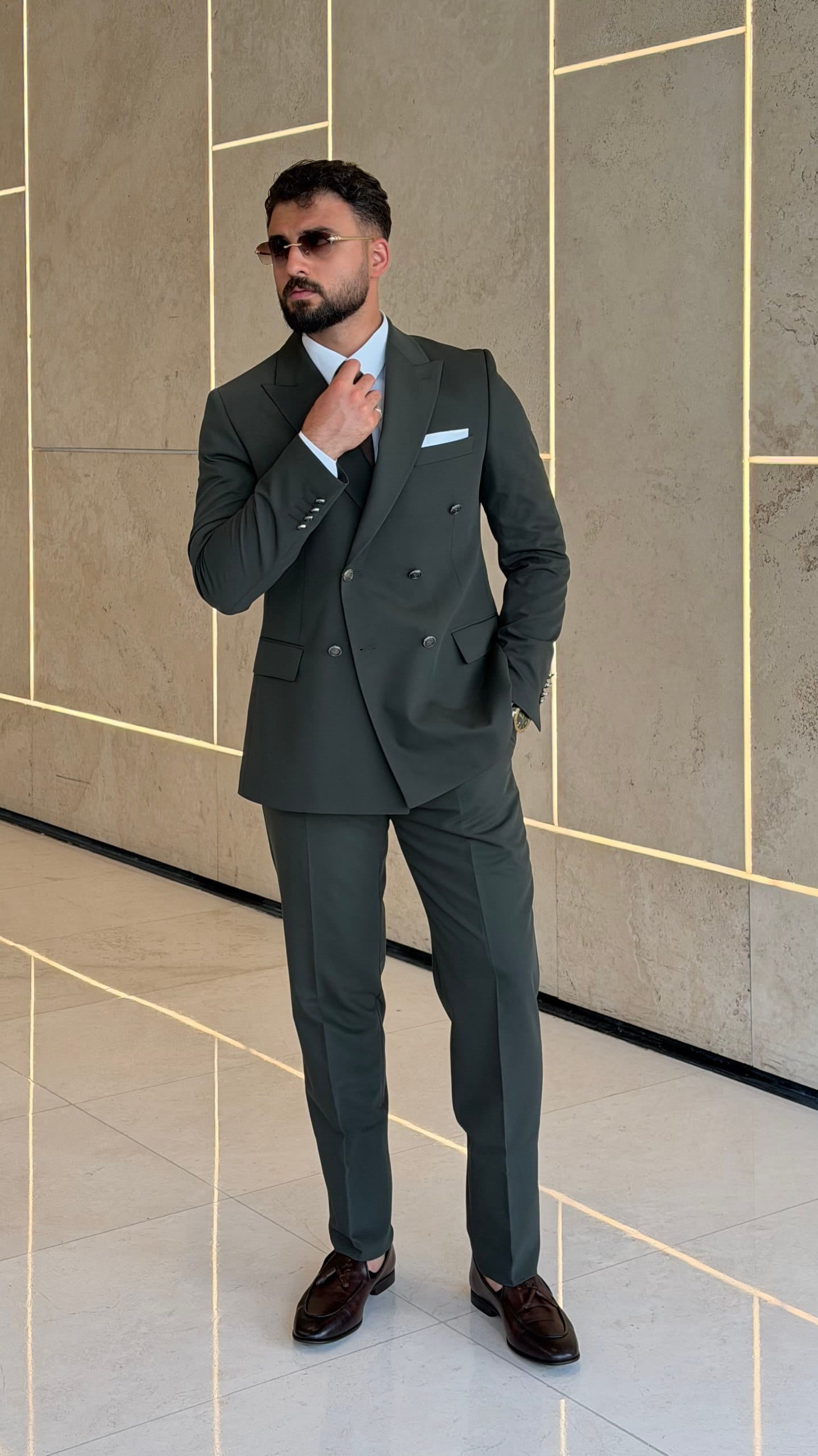 Khaki slim fit suit showing peak lapel and dark buttons