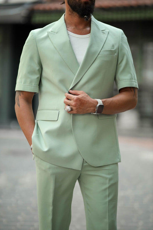 Men’s green short-sleeve tailored summer suit styled for outdoor events.