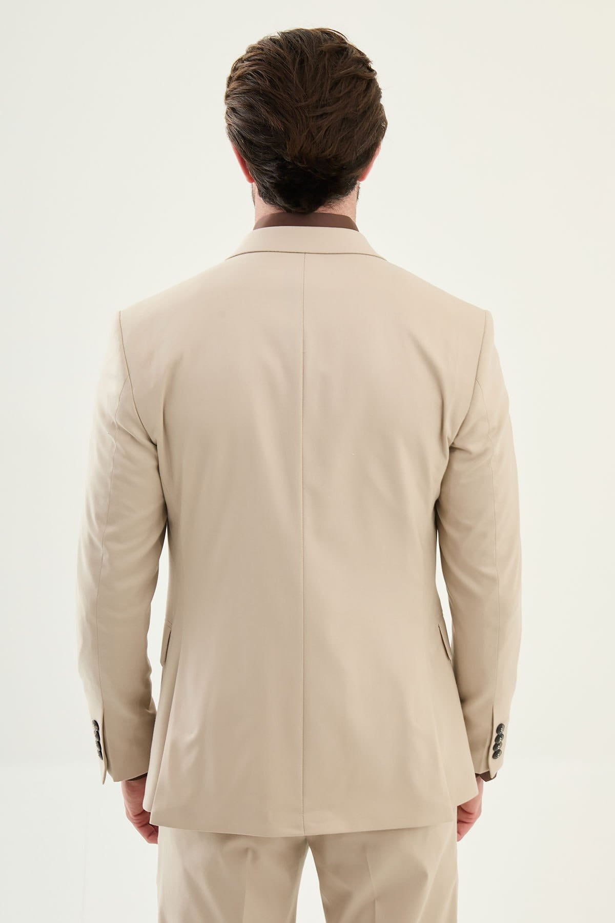 Beige suit worn by a man on a white background