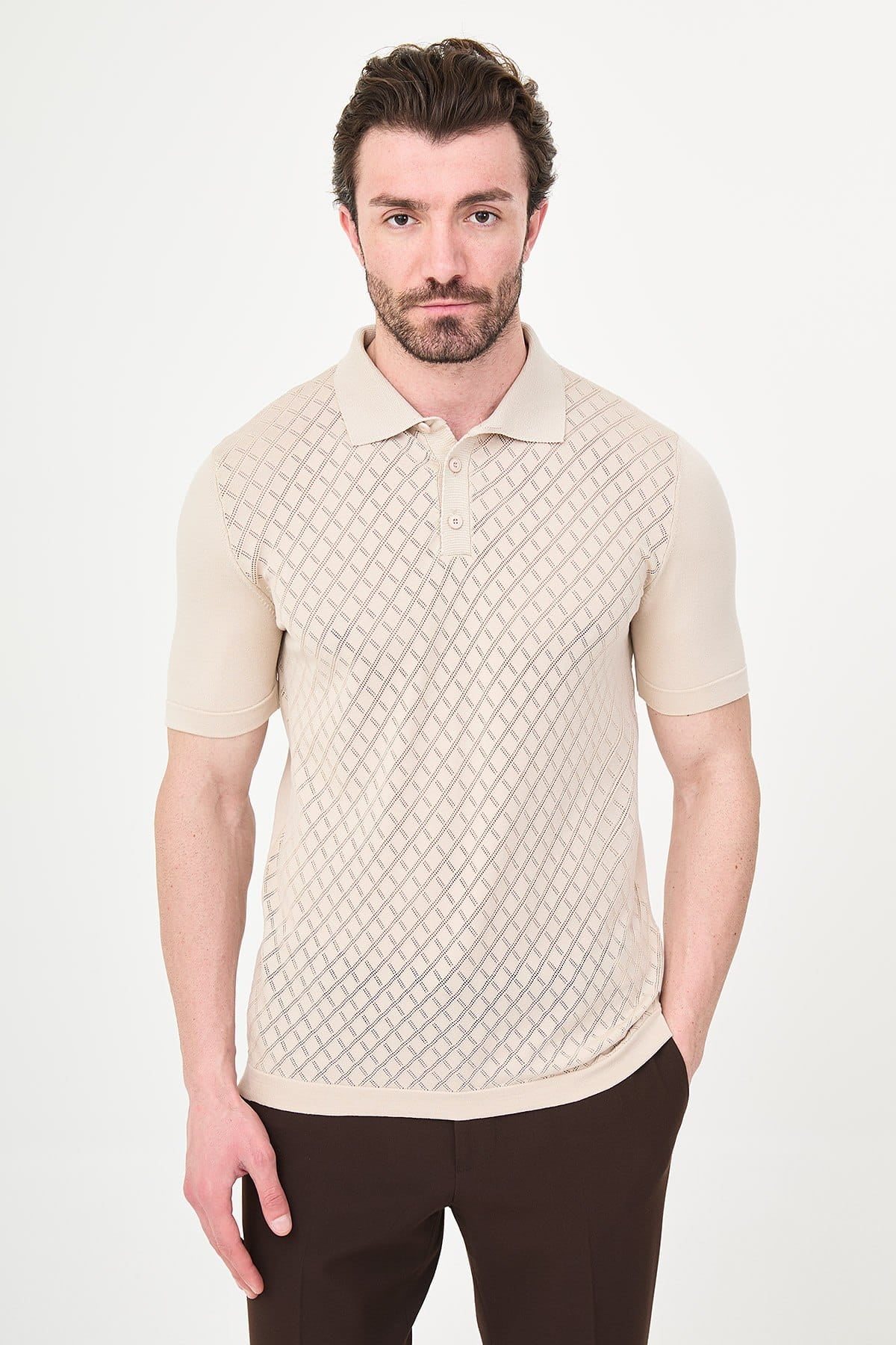 Man wearing a textured beige polo shirt on a white background