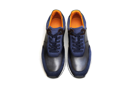Pair of blue and orange sneakers on a white background