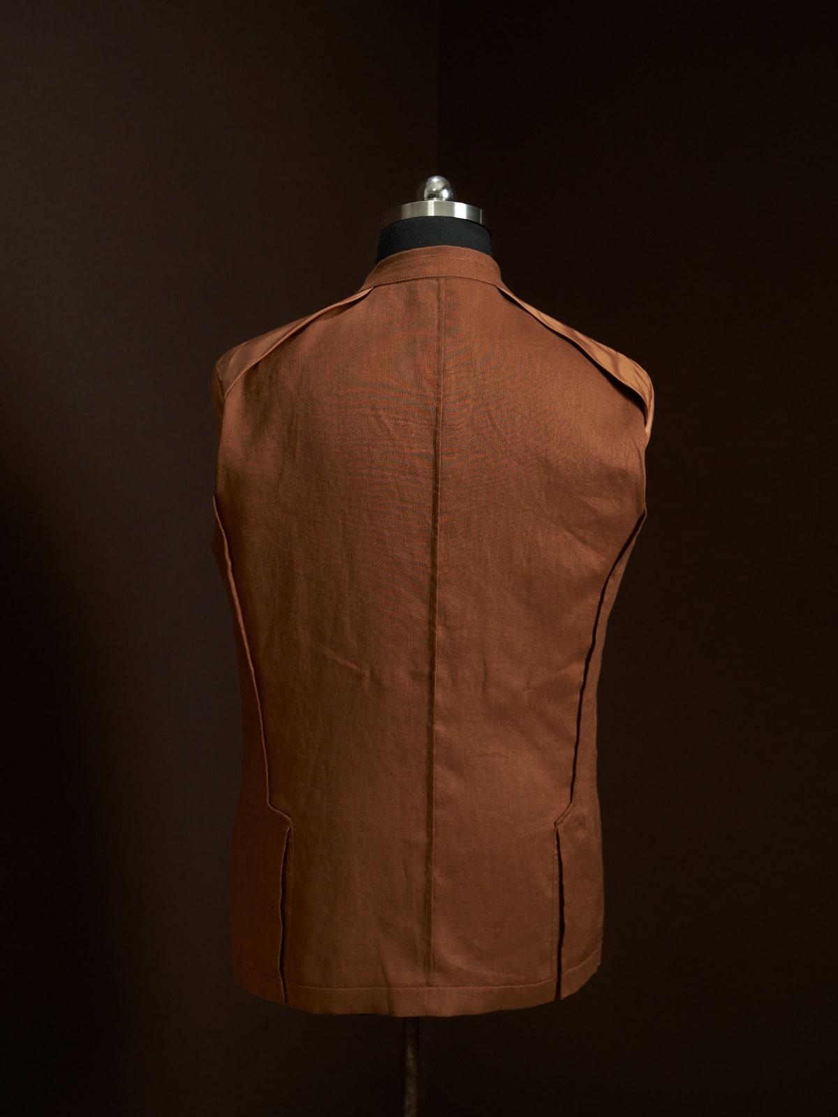 Brown vest on a mannequin against a dark background