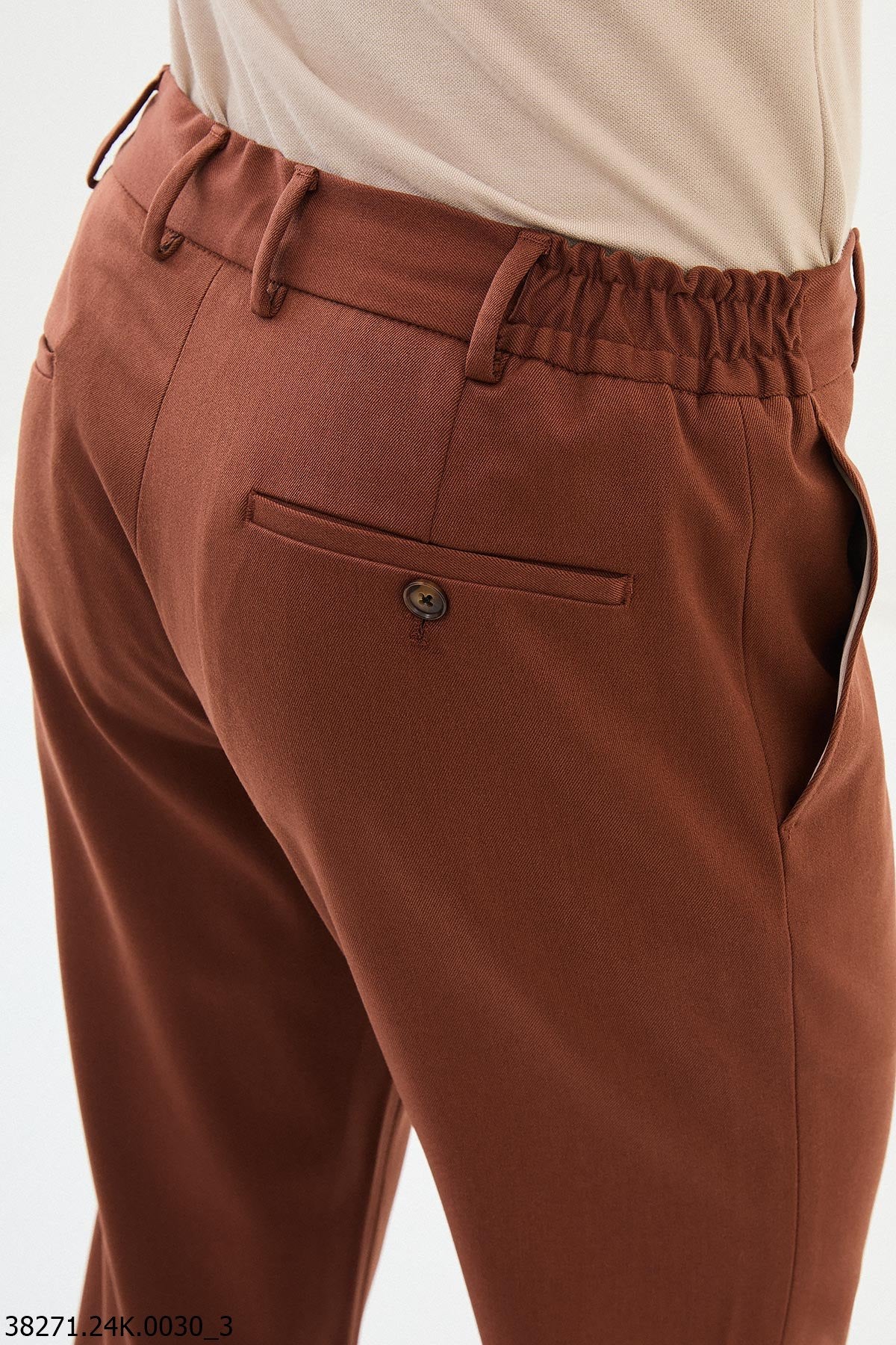 Brown pants with a button on a white background