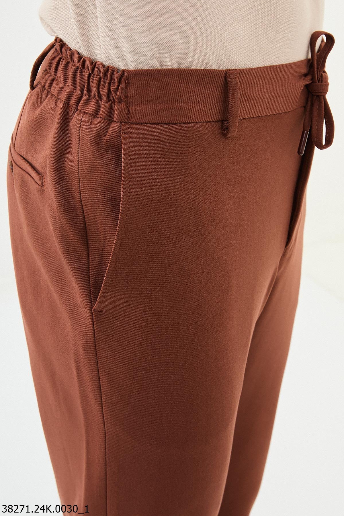 Brown pants with a drawstring on a white background