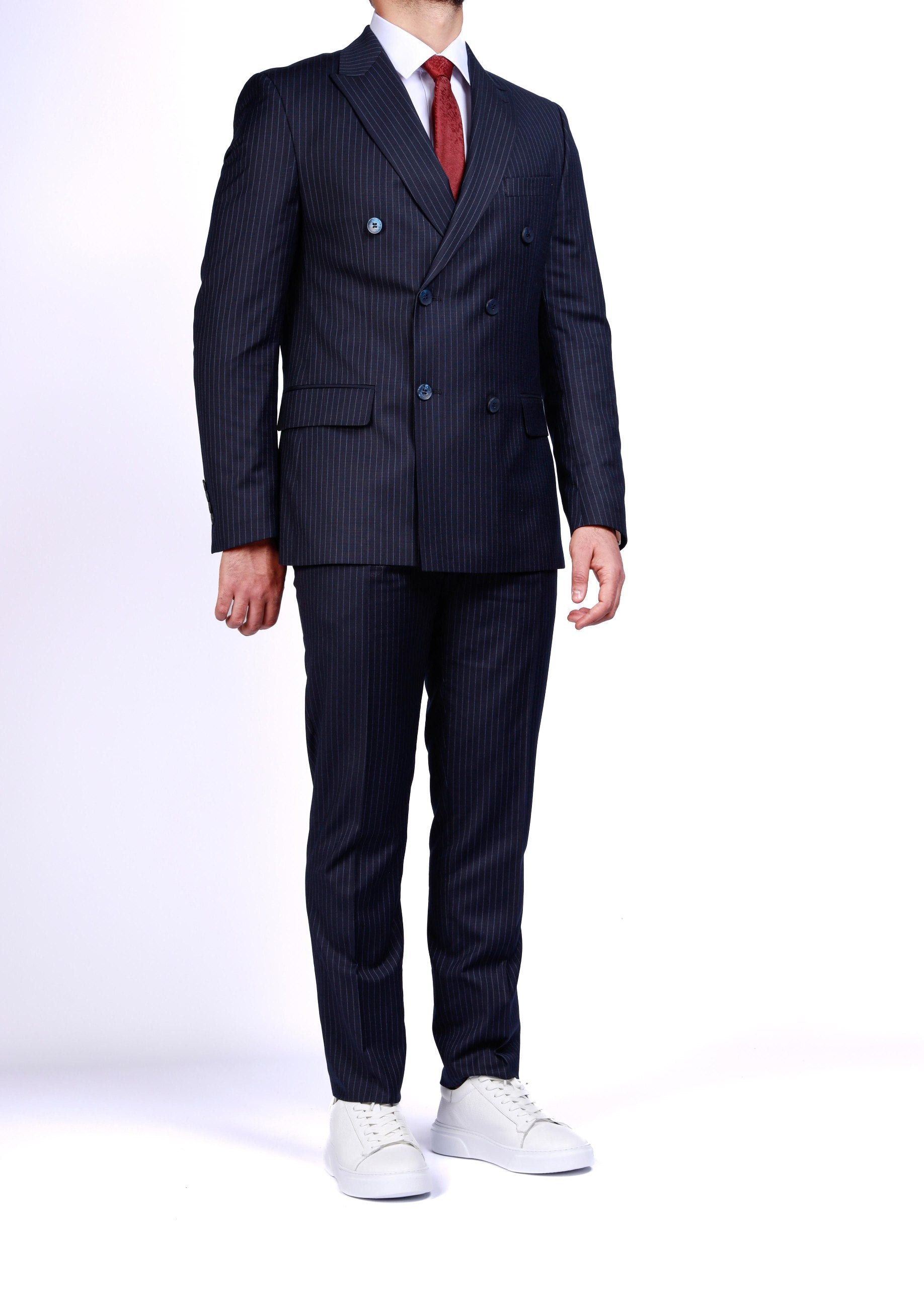 Navy pinstripe suit with white shirt and red tie on a white background