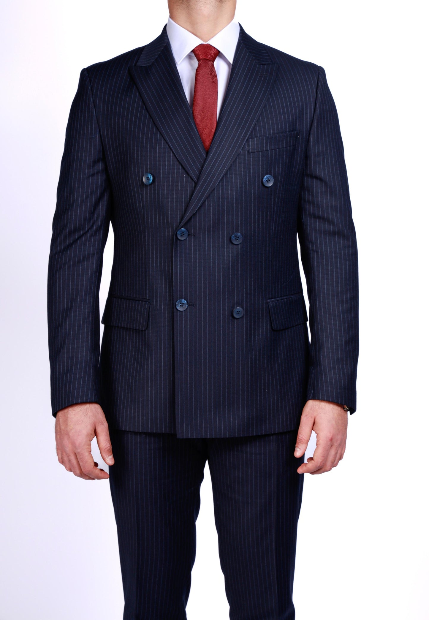 Navy pinstripe suit with a red tie on a white background