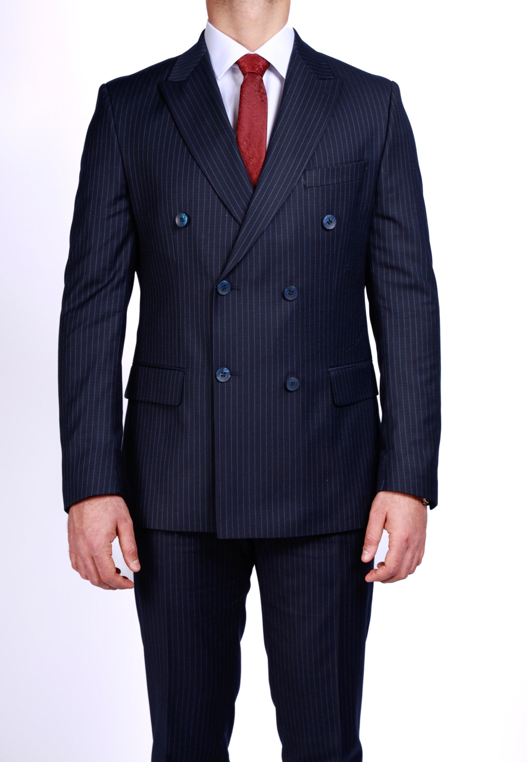 Navy pinstripe suit with a red tie on a white background